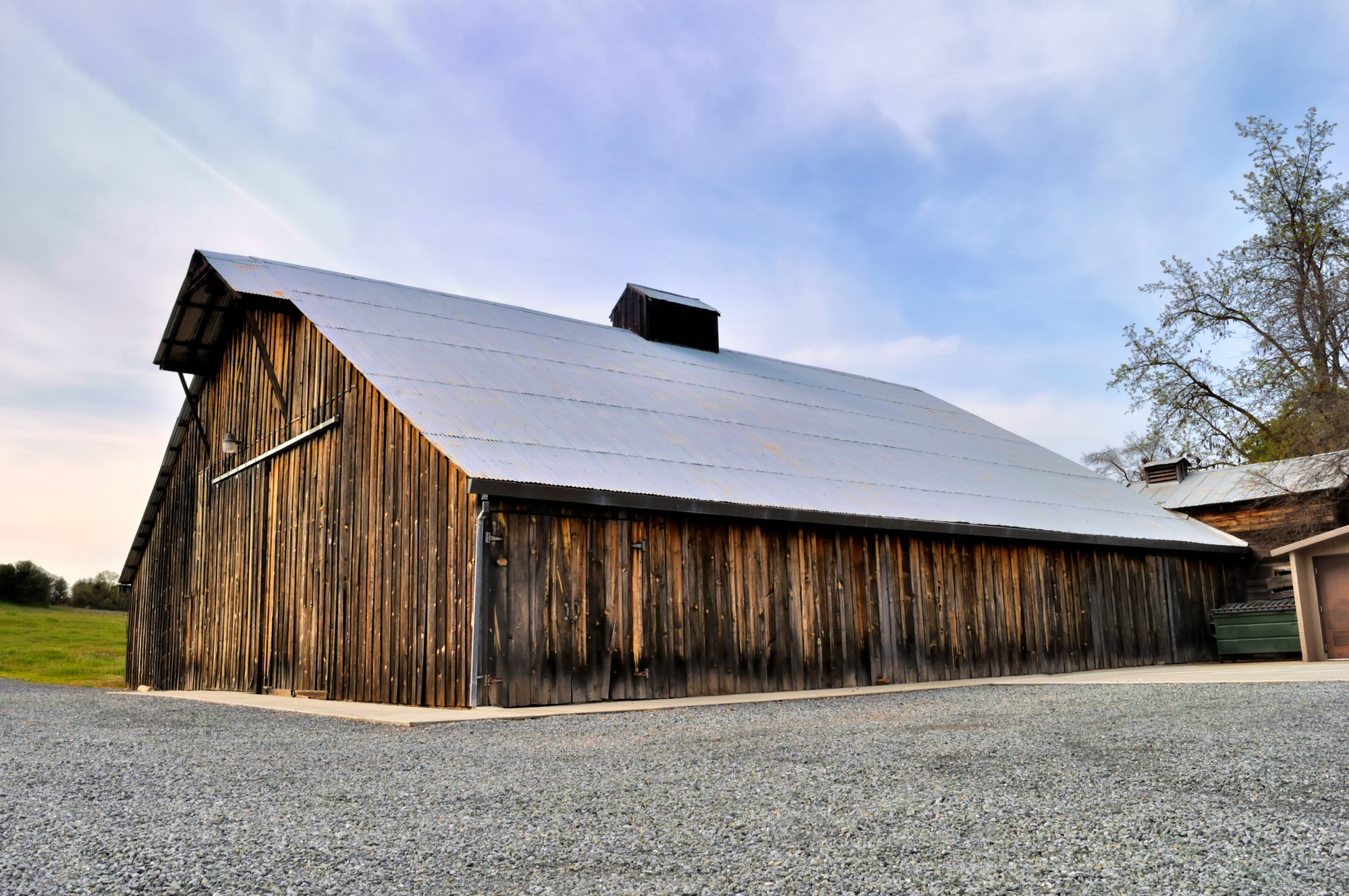 Non-residential wooden warehouse in countryside under clear blue sky